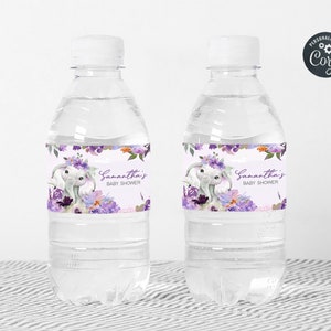 May include: Two clear plastic water bottles with purple and white floral labels. The labels feature a cute elephant with a floral crown and the text "Samantha's Baby Shower".