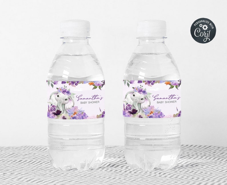 May include: Two clear plastic water bottles with purple and white floral labels. The labels feature a cute elephant with a floral crown and the text "Samantha's Baby Shower".