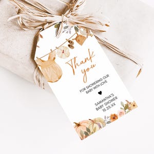 a gift wrapped in brown paper with a tag on it
