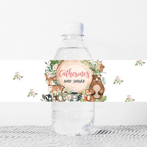 May include: Water bottle label with a woodland theme. The label features a brown bear, a deer, a fox, and an owl. The text on the label reads "Catherine's Baby Shower".