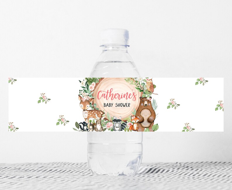 May include: Water bottle label with a woodland theme. The label features a brown bear, a deer, a fox, and an owl. The text on the label reads "Catherine's Baby Shower".