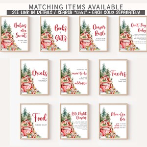 May include: A collection of framed signs with festive watercolor illustrations, including a red truck, Christmas trees, and gift boxes. Text on the signs includes phrases like "Babies are Sweet," "Books & Gifts," and "Diaper Raffle."