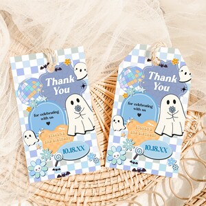 two thank you tags sitting on top of a wicker basket