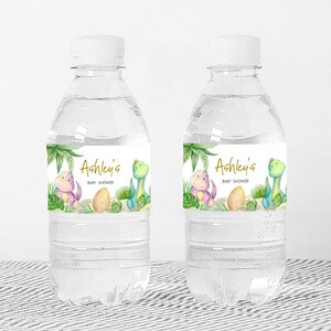 two bottles of water sitting on top of a table