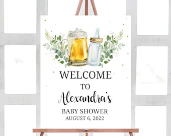 May include: Welcome to Alexandra's Baby Shower sign with a green leafy design, a beer mug, and a baby bottle. The sign says "Welcome to Alexandra's Baby Shower August 6, 2022".