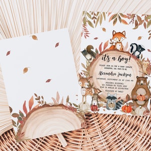 May include: Baby shower invitation with a woodland theme. The invitation features a watercolour illustration of forest animals, including a fox, bear, and deer, surrounding a wooden log with the text "it's a boy!". The invitation is decorated with autumn leaves and pumpkins.