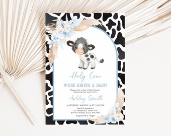May include: A baby shower invitation with a black and white cow print background. The invitation features a cute cartoon cow with blue eyes and a floral design. The text on the invitation reads "Holy Cow We're Having a Baby!" and includes the name "Ashley Smith" and details for the shower.