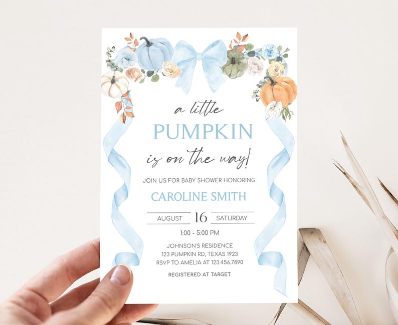 a person holding up a card with a pumpkin on it