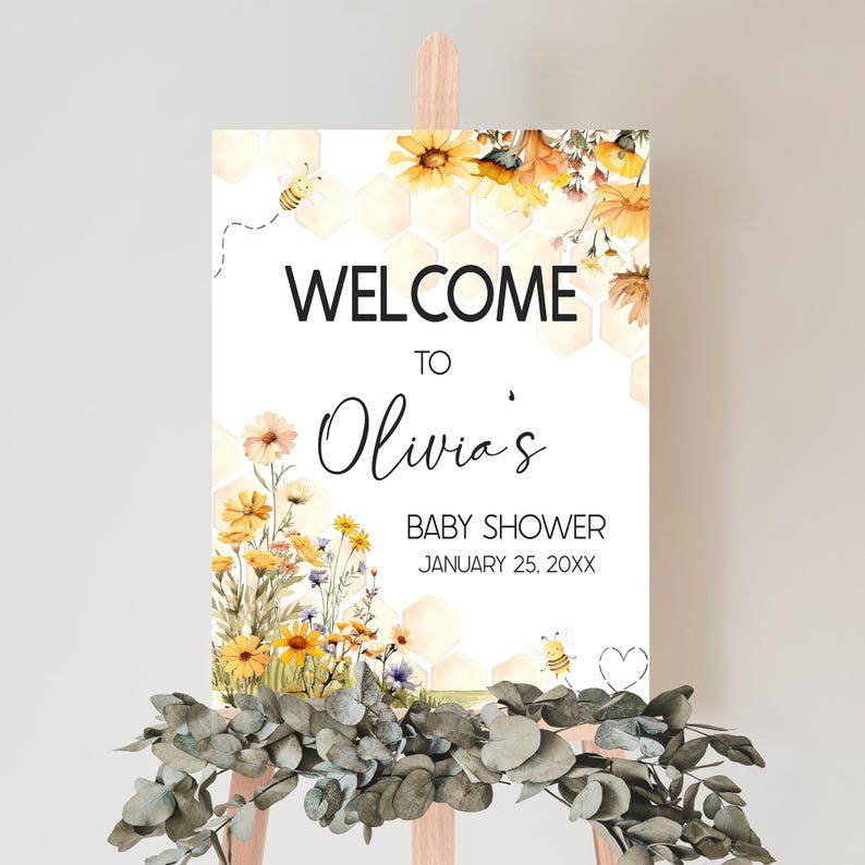a baby shower sign with flowers on it