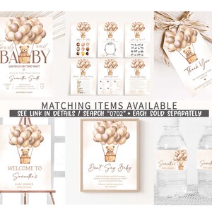 May include: A set of printable baby shower decorations featuring a teddy bear in a hot air balloon with brown, beige, and white balloons. The text on the invitation reads "We can bearly wait Baby Gavin is on the way!" and includes the name Samantha Smith. The text on the welcome sign reads "Welcome to Samantha's Baby Shower". The text on the don't say baby sign reads "Don't Say Baby". The text on the thank you tag reads "Thank You for celebrating with us and baby Samantha's Baby Shower".