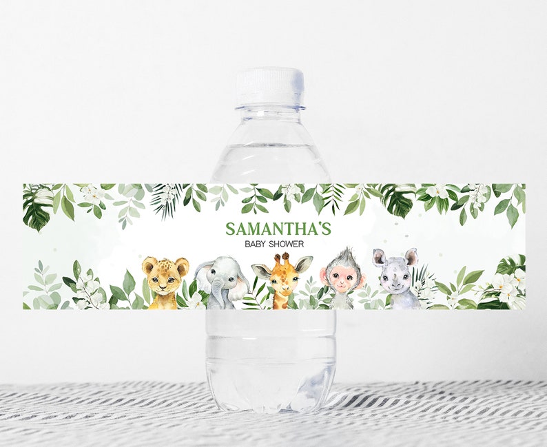 May include: Water bottle label with a green leafy border and a white background. The label features the text "Samantha's Baby Shower" and illustrations of a lion, elephant, giraffe, monkey, and rhinoceros.