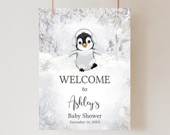 Peut inclure: Panneau de bienvenue pour une baby shower avec une illustration à l'aquarelle d'un pingouin portant des cache-oreilles. Le panneau a un thème hivernal avec des flocons de neige et le texte "WELCOME to Ashley's Baby Shower December 16, 20XX."