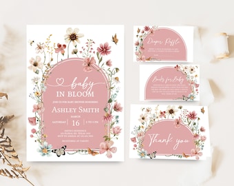 May include: A baby shower invitation with a floral design. The invitation is pink and white with a floral wreath around the text "baby in bloom". The text also includes the name "Ashley Smith", the date "March 16", and the time "2 to 3 PM".