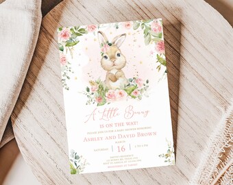 May include: A baby shower invitation with a watercolor illustration of a bunny wearing a floral crown. The invitation says "A Little Bunny is on the Way!" and includes the names Ashley and David Brown, the date March 16, and the time 3 to 5 PM.