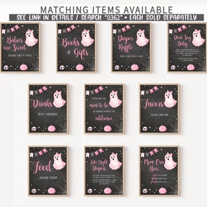 May include: A collection of framed Halloween-themed signs with a chalkboard background. Each sign features a pink ghost illustration, decorative banners, and text such as "Babies are Sweet" and "Books & Gifts".
