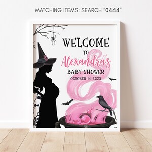 May include: A framed Halloween-themed baby shower sign. The sign features a silhouette of a pregnant witch, bats, and a cauldron with pink smoke. Text reads "Welcome to Alexandra's Baby Shower October 14, 2023".