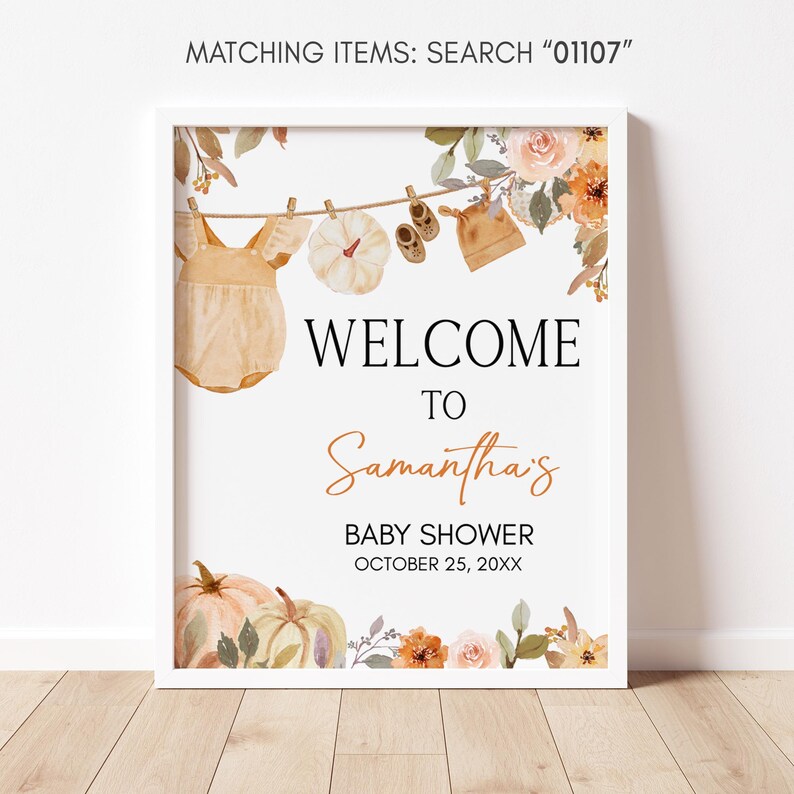 a baby shower sign hanging on a clothes line