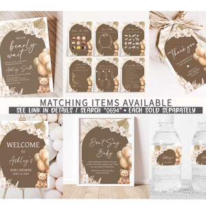 May include: A set of printable baby shower decorations in a brown and beige colour scheme. The decorations feature a teddy bear, balloons, and floral elements. The text on the decorations reads "We can barely wait", "Welcome to Ashley's Baby Shower", "Don't Say Baby", and "Thank you for showering our baby with love".