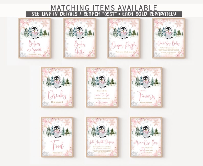 May include: A collection of framed signs with a winter penguin theme. Each sign features a watercolor penguin illustration, pink floral accents, and text such as "Babies are Sweet" and "Drinks". The signs are designed for a baby shower.