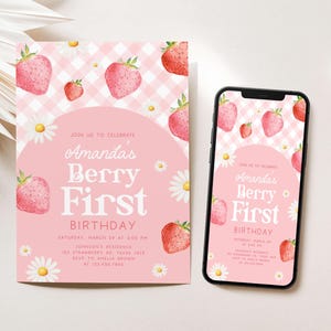 a pink birthday card with strawberries on it next to a phone