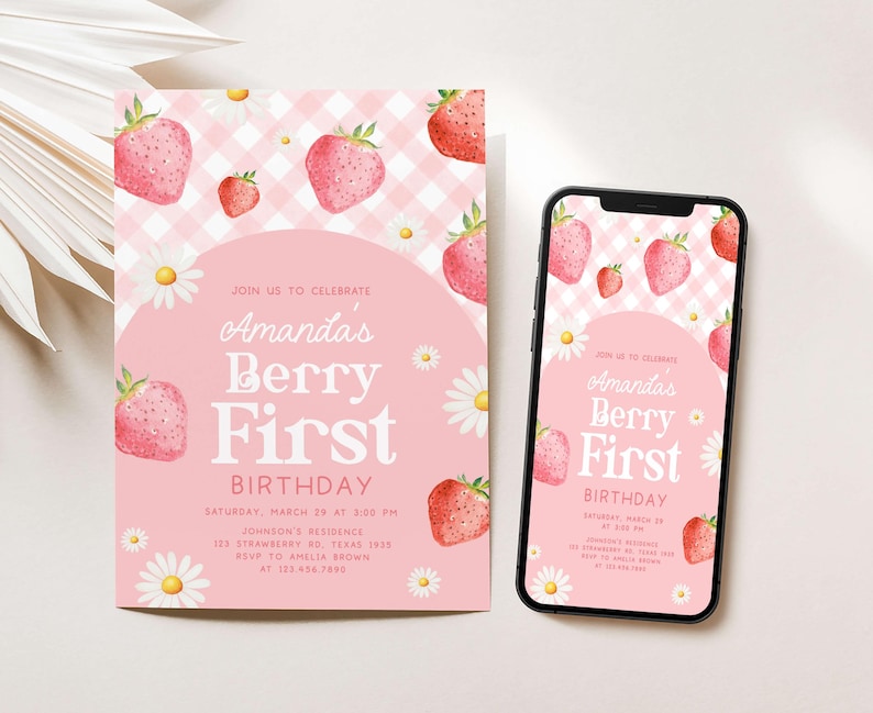 a pink birthday card with strawberries on it next to a phone