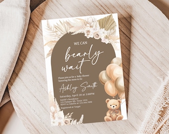 May include: A brown and beige baby shower invitation with a teddy bear holding balloons. The invitation says "We can bearly wait" and includes the name Ashley Smith. The invitation also includes the date, time, and location of the shower.