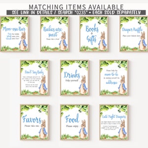 May include: A set of ten printable signs featuring Peter Rabbit illustrations. The signs are for a baby shower and include titles like "Mom-osa Bar", "Babies are Sweet", "Books & Gifts", "Diaper Raffle", "Don't Say Baby", "Drinks", "Please Help the Mom-to-be", "Favors", "Food", and "Late Night Diapers".