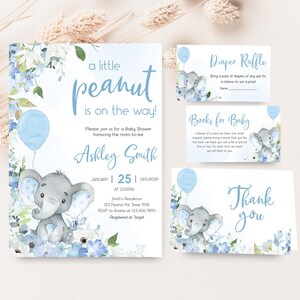 a baby elephant is on the way with a blue balloon