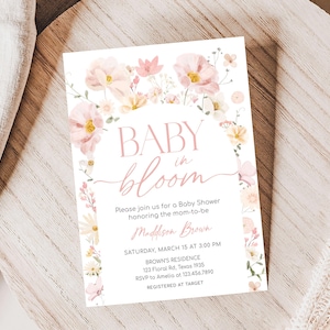 a baby is bloom baby shower card on a plate