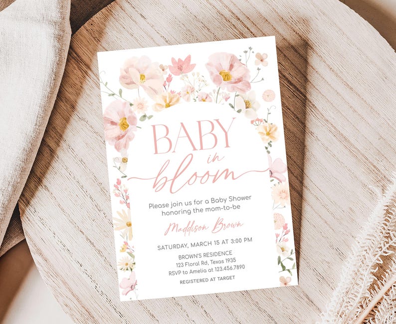 a baby is bloom baby shower card on a plate