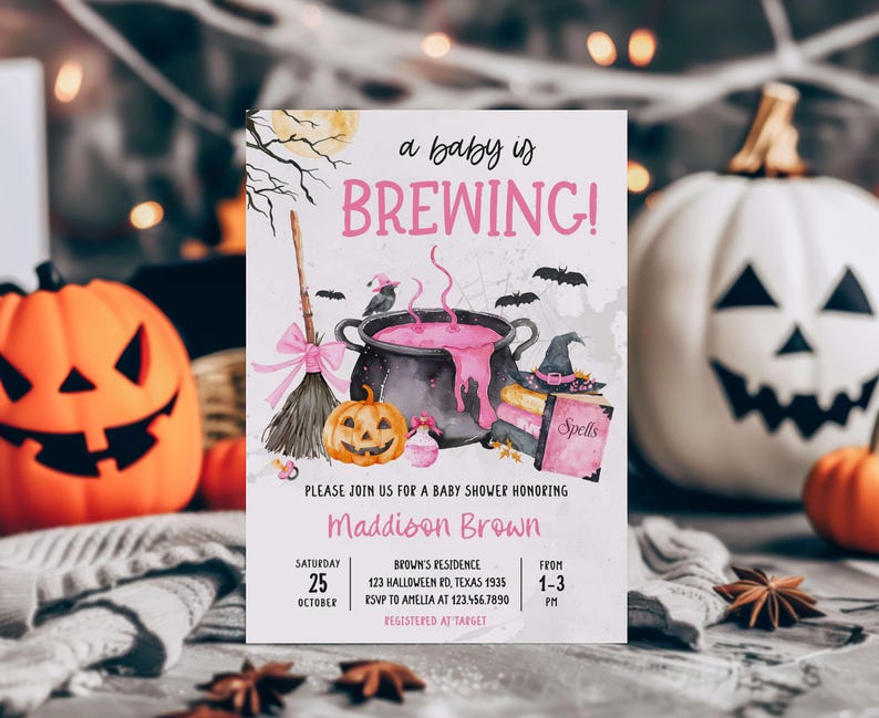A Halloween-themed baby shower invitation featuring a pot of bubbling pink liquid, jack-o-lanterns, and bats, with a pumpkin and broom in the background.