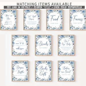 May include: Ten printable signs with blue floral borders and white backgrounds. The signs have text that says "Mom-osa Bar", "Late Night Diapers", "Food Please Enjoy", "Favors Please Take One", "Please Help the Mom-to-be by Making Yourself the Addressee", "Drinks Help Yourself", "Don't Say Baby", "Diaper Raffle Place Your Tickets Here", "Books & Gifts", and "Babies are Sweet Please Take a Treat".