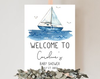 May include: Welcome to Caroline's Baby Shower sign featuring a watercolour illustration of a sailboat on blue water with white seagulls flying overhead. The date is July 27, 20XX.