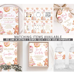 May include: A collection of baby shower stationery with a Christmas theme. Includes invitations, games, a welcome sign, and water bottle labels. Designs feature gingerbread men, Christmas trees, and Santa Claus illustrations in pink and gold.