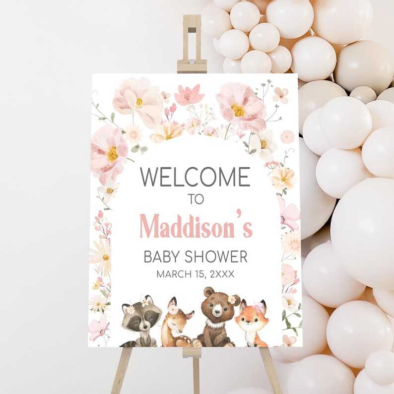 a baby shower sign with balloons in the background