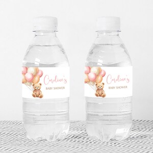 a bottle of water with a teddy bear on it