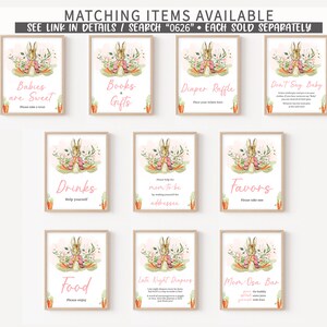 K&ouml;nnte beinhalten: Satz von 9 druckbaren Schildern mit einer Aquarell-Illustration eines Kaninchens in einem rosa Kleid und Blumen. Die Schilder haben Text, der "Babies are Sweet", "Books & Gifts", "Diaper Raffle", "Don't Say Baby", "Drinks", "Mom to be addressee", "Favors", "Food", "Late Night Diapers" und "Mom Osa Bar" lautet.