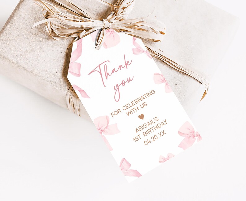 a gift wrapped in brown paper with a pink bow