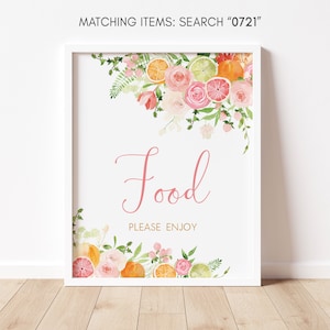 May include: A white framed sign with a floral border of pink roses and citrus fruit slices. The sign says "Food" in pink script and "Please Enjoy" in black text.