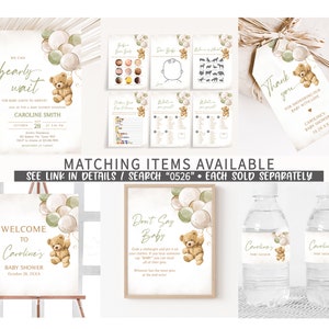 May include: A set of printable baby shower decorations featuring a teddy bear holding balloons. The decorations include a welcome sign, a don't say baby game, water bottle labels, and a thank you tag. The theme is a woodland baby shower with green and brown colors.