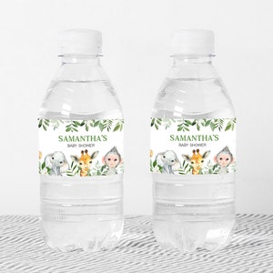 May include: Two clear plastic water bottles with green and white labels. The labels feature a jungle theme with an elephant, giraffe, and monkey. The text on the labels reads "Samantha's Baby Shower".
