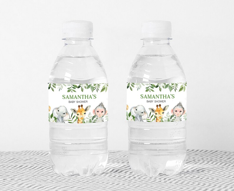 May include: Two clear plastic water bottles with green and white labels. The labels feature a jungle theme with an elephant, giraffe, and monkey. The text on the labels reads "Samantha's Baby Shower".