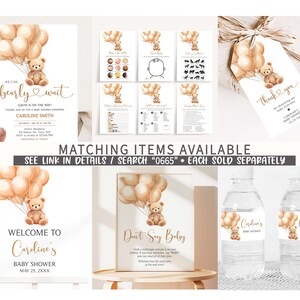 May include: A set of printable baby shower decorations featuring a teddy bear holding balloons. The set includes a welcome sign, a don't say baby sign, water bottle labels, and a thank you tag. The decorations are in a neutral color palette of brown, beige, and gold.