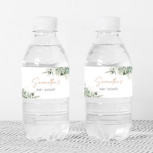 two water bottles with labels on them sitting on a table