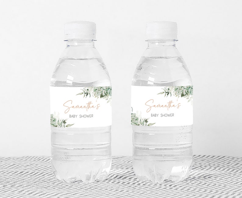 two water bottles with labels on them sitting on a table