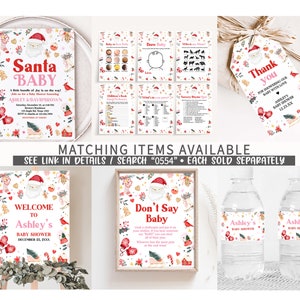 May include: A collection of Christmas-themed baby shower decorations. Includes invitations, game cards, a welcome sign, and water bottle labels. The designs feature Santa Claus, mittens, and festive elements. The text reads "Santa Baby" and "Ashley's Baby Shower".
