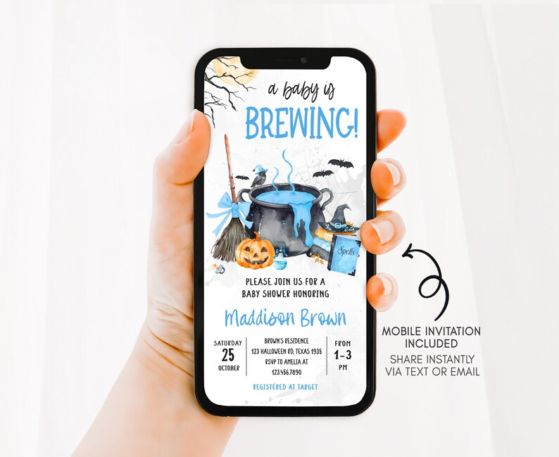 A hand holding a smartphone displaying an invitation for a baby shower.