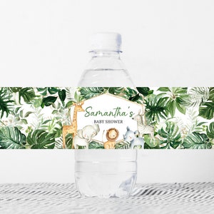 May include: Water bottle label with a jungle theme. The label features green leaves, a giraffe, an elephant, a lion, a rhinoceros, and a zebra. The text on the label reads "Samantha's Baby Shower".