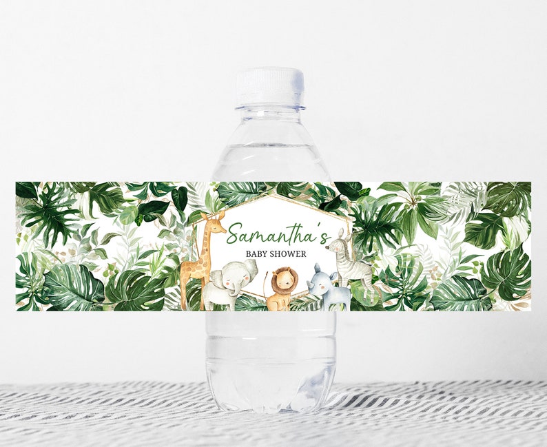May include: Water bottle label with a jungle theme. The label features green leaves, a giraffe, an elephant, a lion, a rhinoceros, and a zebra. The text on the label reads "Samantha's Baby Shower".