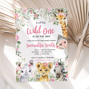 May include: A pink and green baby shower invitation with a floral border and a watercolour illustration of a giraffe, monkey, rhino, lion, and zebra. The text reads "A Little Wild One Is On The Way!" and includes the name "Samantha Smith" and details for the baby shower.